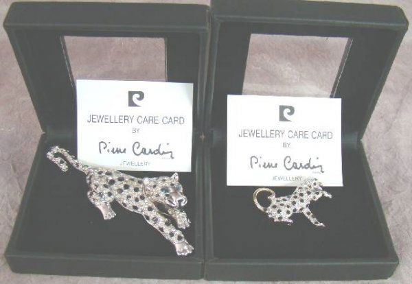 2 BOXED PIERRE CARDIN BROOCHES: 2 BOXED PIERRE CARDIN BROOCHES , both are modelled as cats, the largest has blue eyes, and the other emerald green, and both are set with black spots, and diamante. The largest is 10.5cm long. The bac