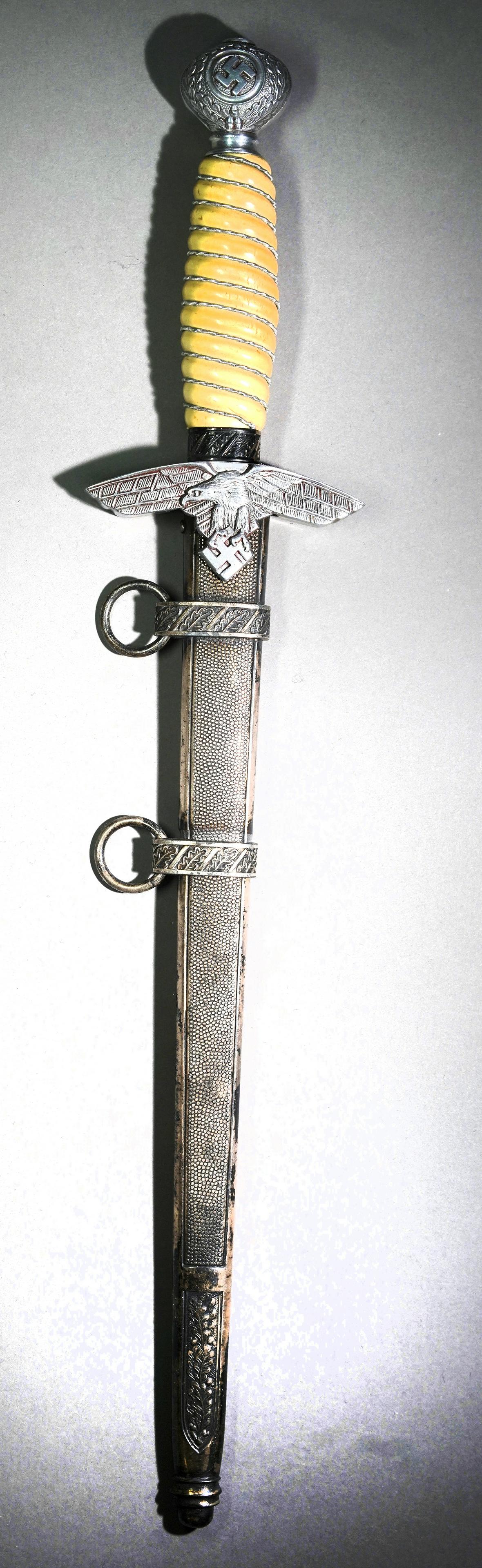 GERMAN 2nd MODEL LUFTWAFFE DAGGER M1937: GERMAN 2nd MODEL LUFTWAFFE DAGGER M1937. Unsharpened 10-inch blade marked, WKC Solingen + logo. Leather buffer is intact. The cross guard in a semi-Art Deco style shows an eagle in flight holding a sw