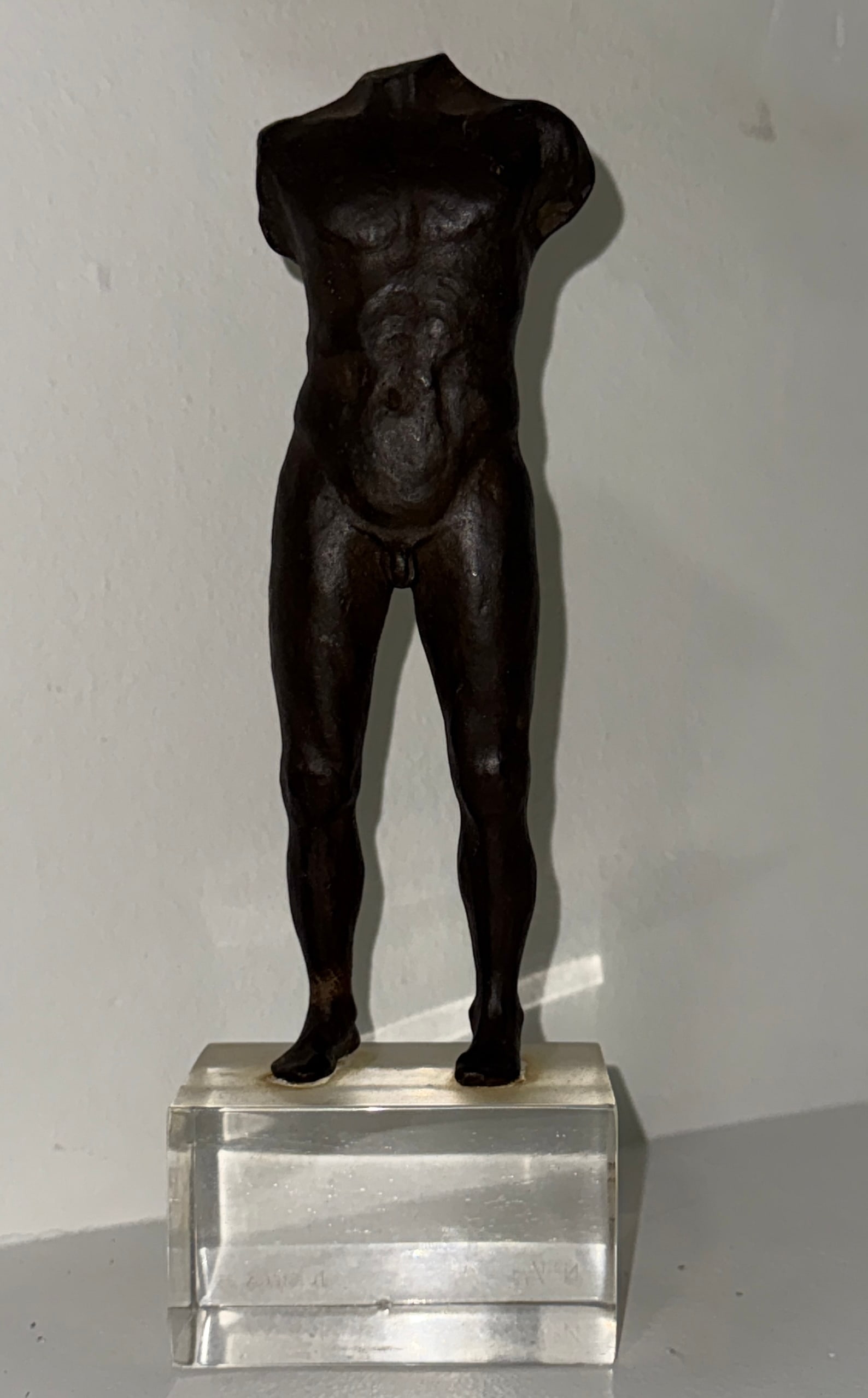 Iron Sculpture of Headless man with Glass base Signed: Iron Sculpture of Headless man with Glass base, signed and numbered on vase.