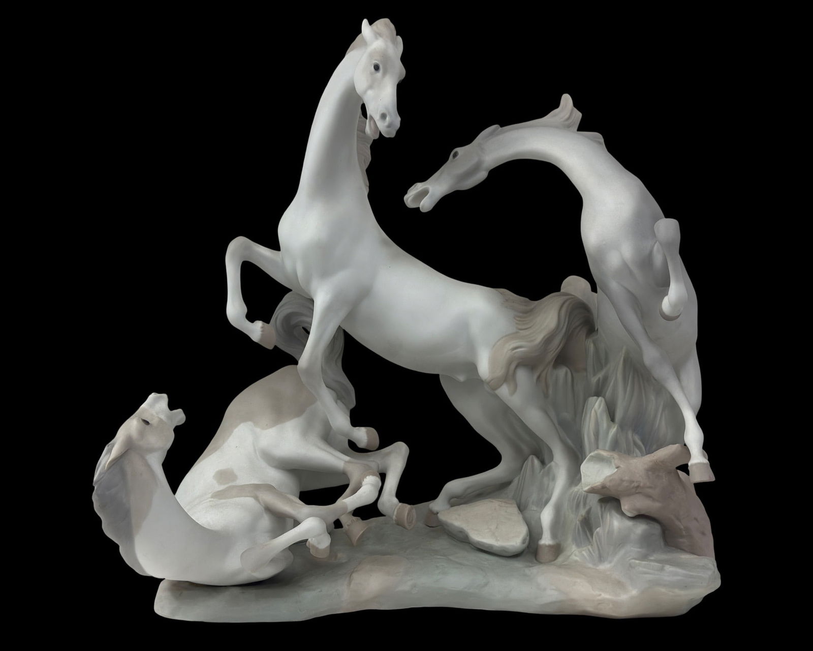 Lladro Spanish Porcelain Horses Statue Model #1022: A Lladro Spanish porcelain glazed centerpiece sculpture. Titled, "Horses Group," model number 1022. A striking figural group produced circa 1980s, by artist Fulgencio Garcia, depicting a trio of