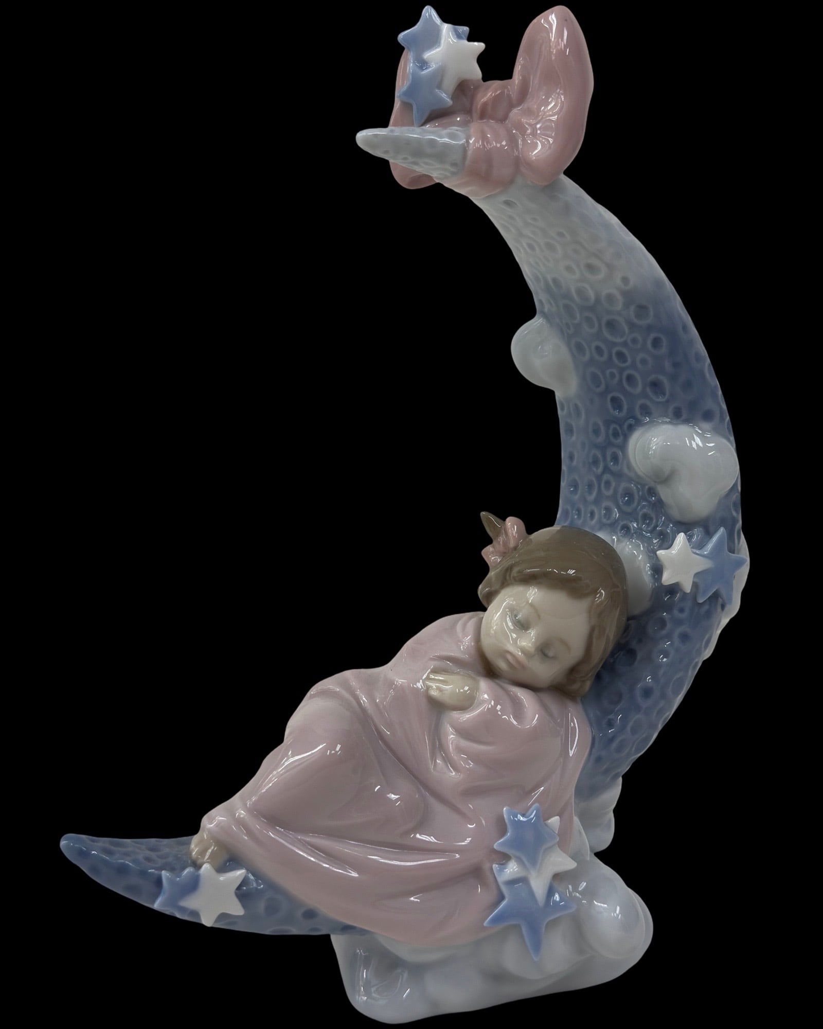 LLADRO HEAVEN'S LULLABY PORCELAIN FIGURINE 01006583: LLADRO HEAVEN'S LULLABY PORCELAIN FIGURINE 01006583Lladro porcelain figurine titled 'Heaven's Lullaby,' model number 6583. Depicts a child sleeping on a crescent moon adorned with stars, clouds, and