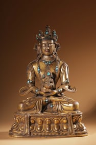 A fine Qing bronze gilt inlaid turquoise longevity Buddha seated statue