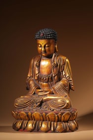 A seated statue of Shakyamuni in clear sandalwood lacquered gold