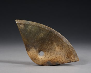 A tall antique jade axe