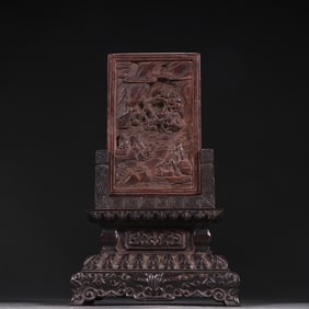 A Qing Dynasty agarwood carved mountain stone figure with a small leaf red sandalwood base