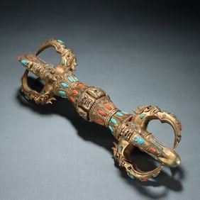 A copper gold-plated diamond pestle embedded with gemstones