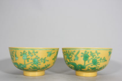 A clear, bright yellow, green, flower and bird patterned bowl