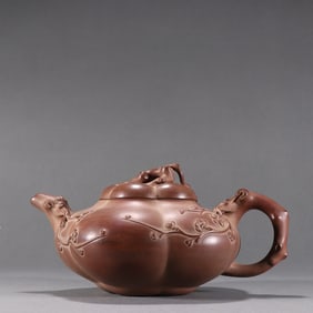 A Guilin style purple clay plum blossom patterned teapot