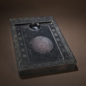 A Wang Shoupeng style antique stone carving with double dragons holding longevity inkstone