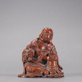 A bamboo carved bangs playing with a golden toad ornament