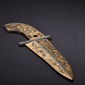 A piece of gold, silver, bird, and animal patterned dagger