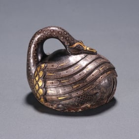 A copper inlaid gold and silver ornament