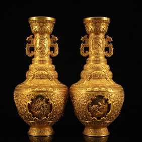 A pair of gilt turn-heart vases