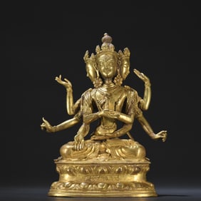 A bronze gilded three sided eight armed sitting statue of Guanyin