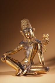 A fine Qing bronze gilt inlaid gemstone sitting statue of Guanyin