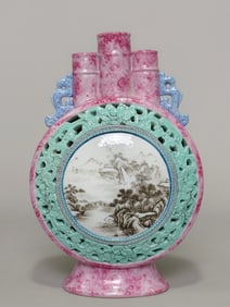 A clear pink three mouthed moon hugging bottle