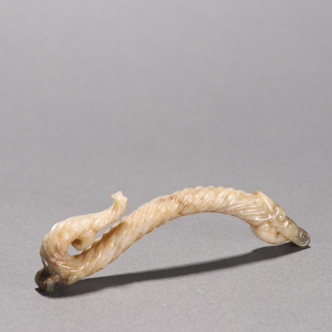 An ancient jade dragon-shaped carving (1 of 9)