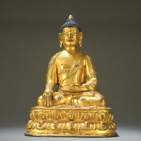 A Qing Dynasty bronze gilt statue of Shakyamuni Buddha