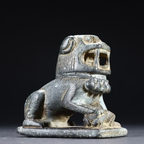 A small stone lion on the desk