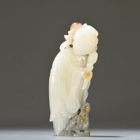 A Hetian jade blue and white seed figure ornament