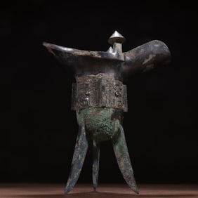 A bronze silver three-legged cup