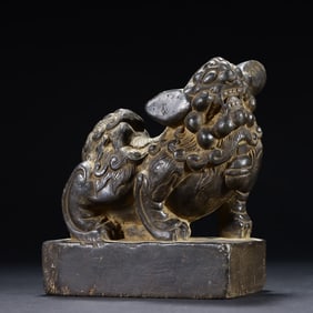 A small stone lion on the desk