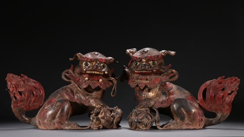 A pair of Qing Dynasty bronze gilt lion play ball ornaments