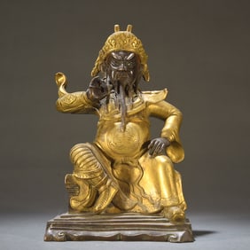 A Qing Dynasty bronze gilt statue of Guan Gong