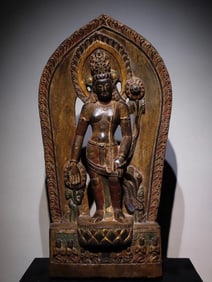 A painted statue of Kannon standing