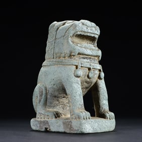 A small stone lion on the desk