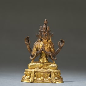 A Qing Dynasty bronze gilt four-armed Guanyin statue