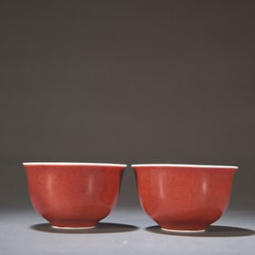 A pair of monochrome red glazed cups