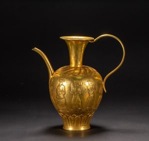 A bronze gilt figure holding a pot