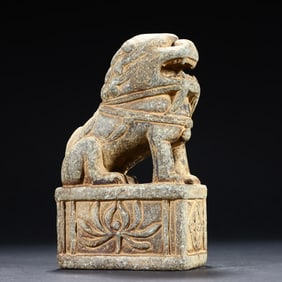A small stone lion on the desk