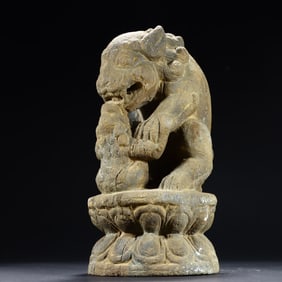A small stone lion on the desk
