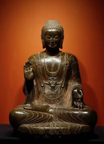 A Northern Qi bluestone painted seated statue of Shakyamuni Buddha