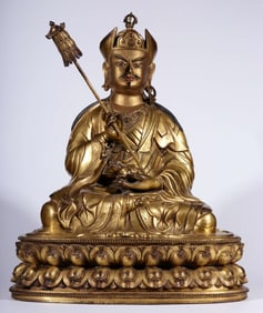 A Qing Dynasty bronze gilt lotus master sitting statue of the God of Wealth