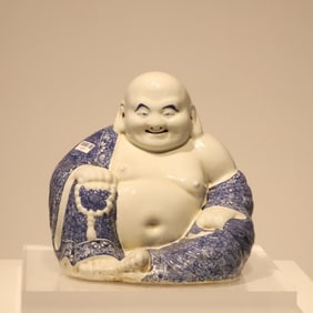 A late Qing Dynasty blue and white robe Maitreya Buddha statue