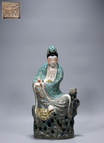 Deng Yifu made a pastel bamboo leaf holding a scripture book and sitting on a stone Guanyin statue