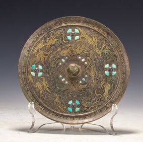 A wrong gold and silver turquoise bronze mirror