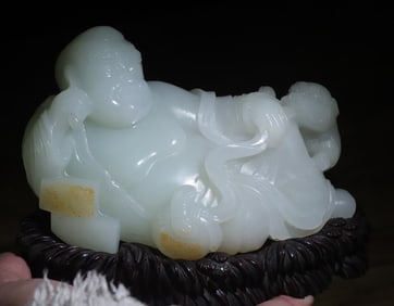 A white jade ear-digging Arhat ornament