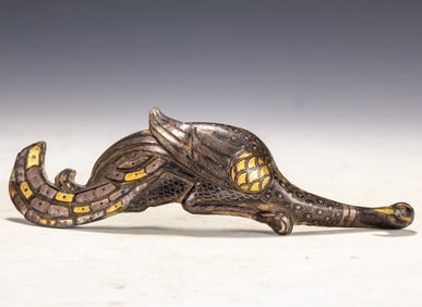 A piece of wrong gold and silver with a hook