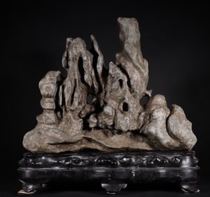 A piece of the old Tibetan mid-Qing Dynasty hump Lingbi stone Shanzi ornament with a mahogany base