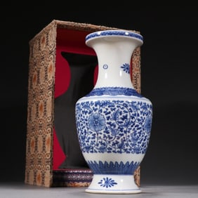 A clear blue and white twig with a pattern plate bottle