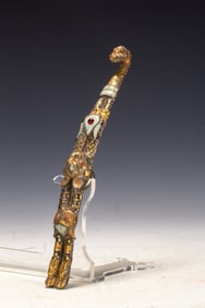 A piece of wrong gold and silver with a hook