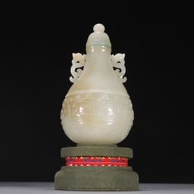 A piece of Qing Hetian jade seed material carved gluttonous pattern dragon ear bottle