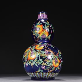 A glass and colored pomegranate pattern gourd bottle