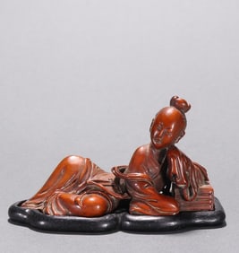 A Qing boxwood carved maid ornament