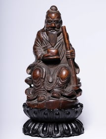 A seated statue of an old man carved in bamboo carving in the Qing Dynasty