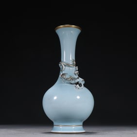 A blue glazed relief depicting a gold dragon bottle